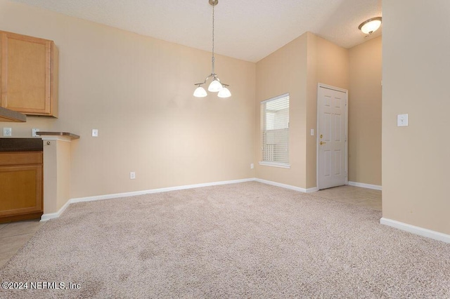 interior space featuring light colored carpet, baseboards, and an inviting chandelier