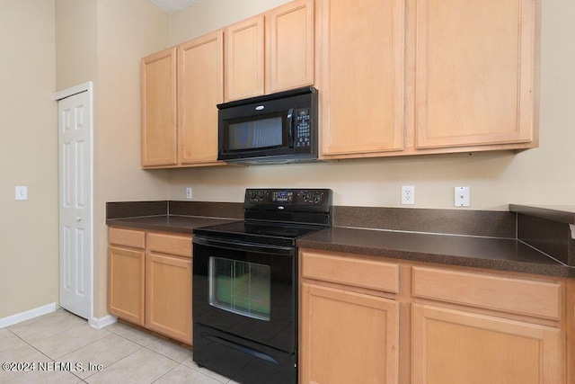 kitchen featuring light tile patterned floors, baseboards, dark countertops, light brown cabinetry, and black appliances