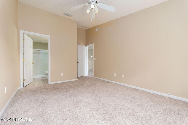 unfurnished bedroom featuring light carpet, visible vents, and baseboards