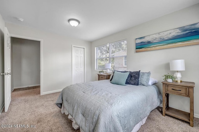 bedroom featuring light carpet and a closet