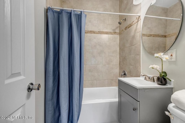 full bathroom with vanity, toilet, and shower / tub combo with curtain