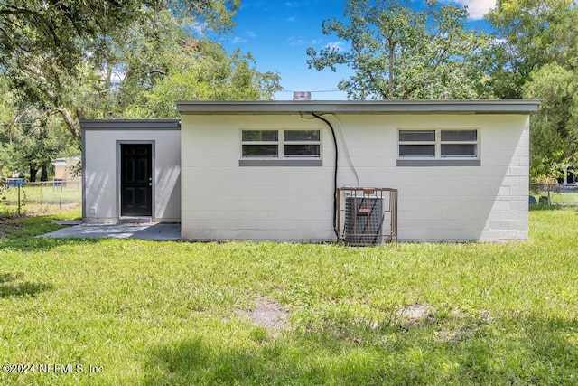 rear view of house with a lawn