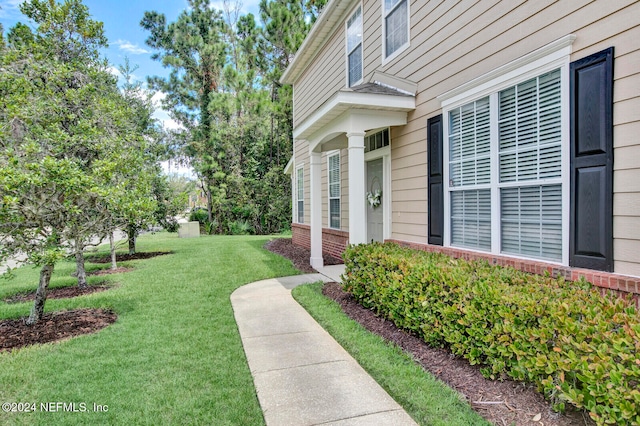 property entrance with a yard