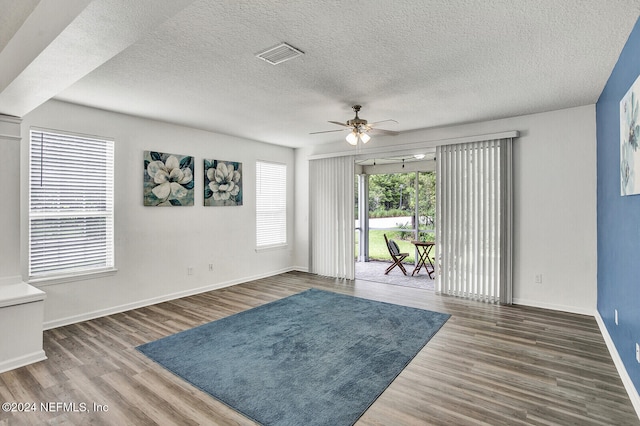 interior space featuring hardwood / wood-style flooring, a textured ceiling, and ceiling fan