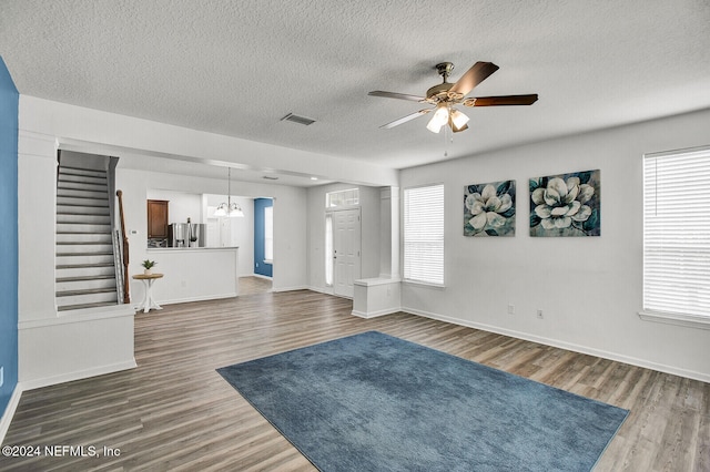 unfurnished living room with ceiling fan, hardwood / wood-style floors, and a healthy amount of sunlight