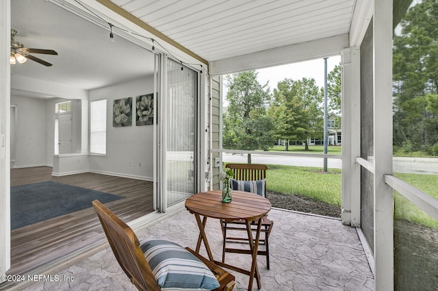 sunroom / solarium featuring ceiling fan