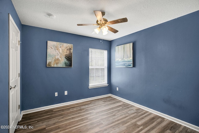 empty room with hardwood / wood-style flooring, a textured ceiling, and ceiling fan