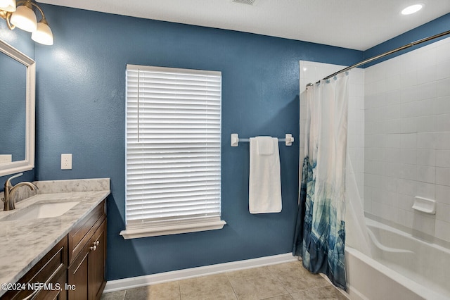 bathroom featuring tile patterned flooring, vanity, and shower / tub combo