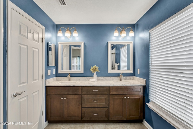 bathroom with tile patterned flooring and vanity