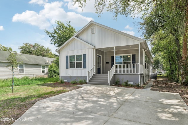 view of front of house featuring stairway, covered porch, and crawl space
