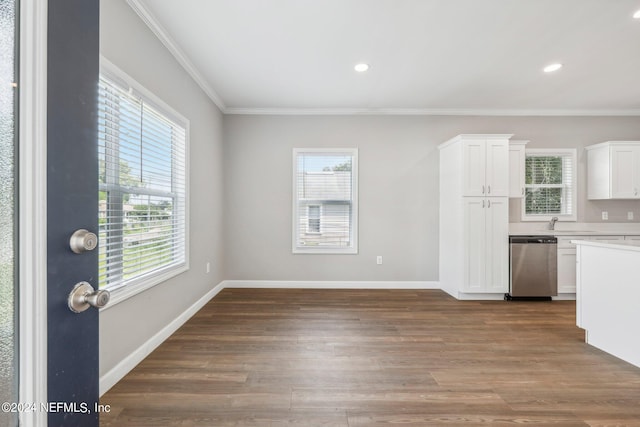 kitchen featuring a wealth of natural light, dishwasher, and white cabinetry