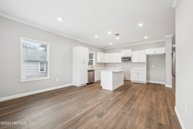 kitchen with appliances with stainless steel finishes, baseboards, and wood finished floors