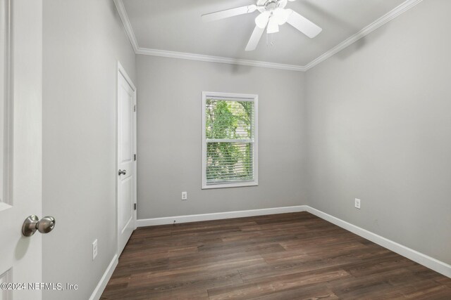 spare room with a ceiling fan, crown molding, baseboards, and dark wood finished floors