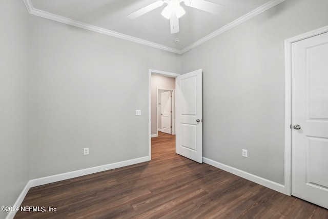 unfurnished bedroom with baseboards, ornamental molding, and dark wood finished floors