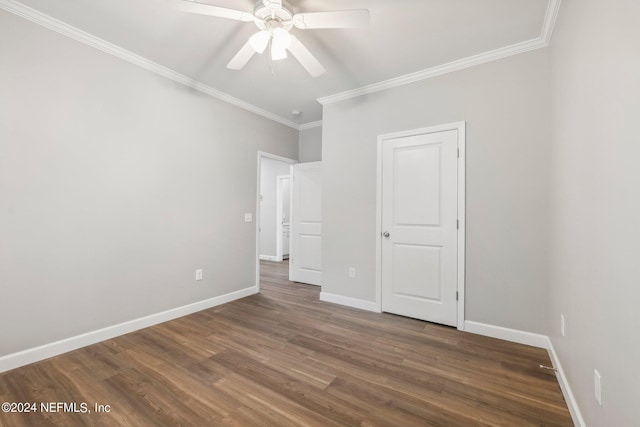 unfurnished bedroom with baseboards, ornamental molding, wood finished floors, and a ceiling fan