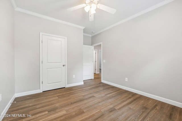 unfurnished bedroom featuring ornamental molding, baseboards, ceiling fan, and wood finished floors