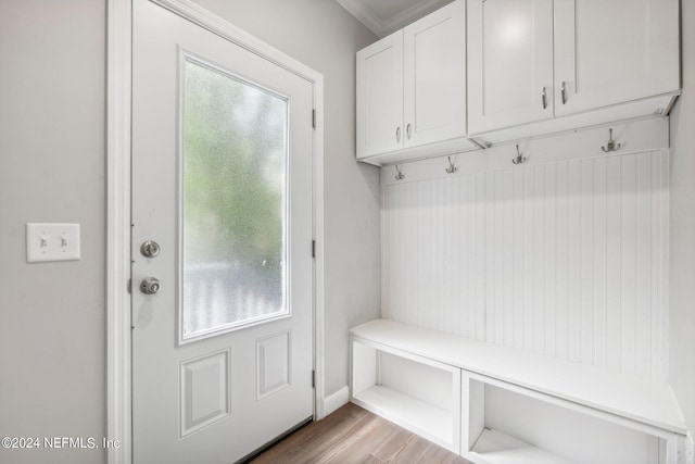 mudroom with ornamental molding and wood finished floors
