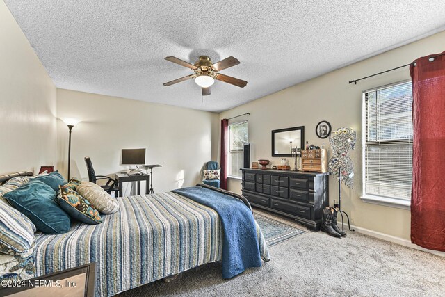 bedroom with carpet, a textured ceiling, and ceiling fan