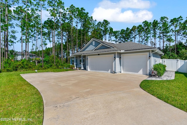 single story home featuring an attached garage, a gate, fence, driveway, and a front lawn