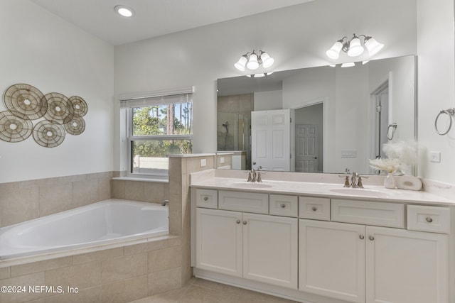 full bath with double vanity, tile patterned flooring, a shower stall, and a sink