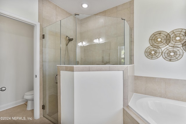 bathroom featuring toilet, tile patterned flooring, a shower stall, and a bath