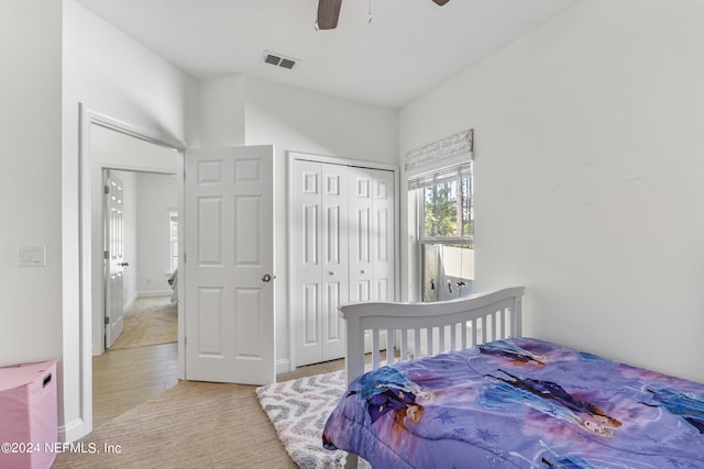 bedroom with ceiling fan, visible vents, and a closet