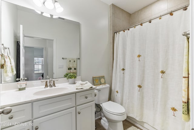 bathroom featuring shower / tub combo with curtain, vanity, and toilet