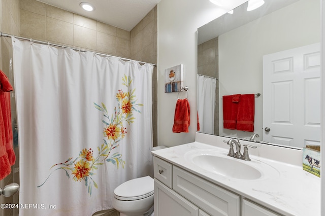 bathroom featuring a shower with curtain, vanity, and toilet