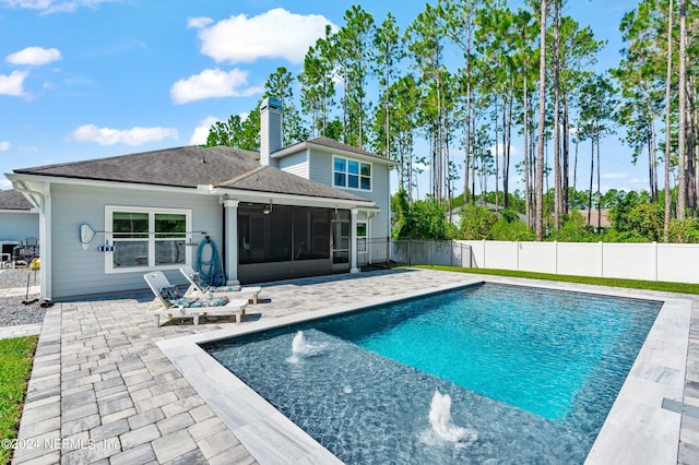 view of swimming pool featuring a patio, pool water feature, and a sunroom