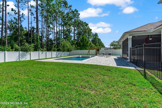 view of yard with ceiling fan, a patio area, a fenced backyard, and a fenced in pool