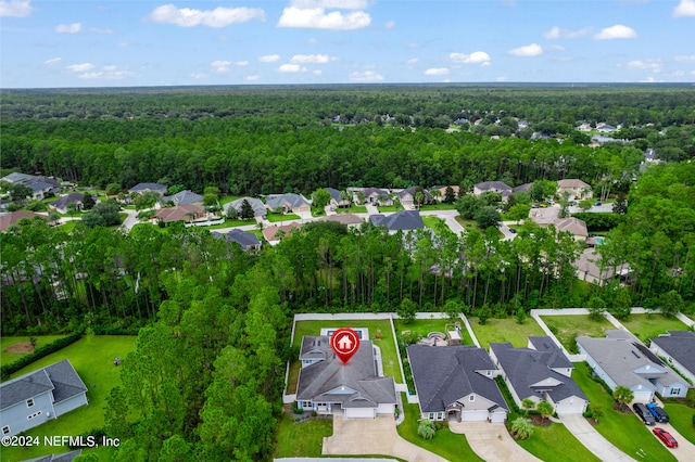 aerial view featuring a residential view and a wooded view