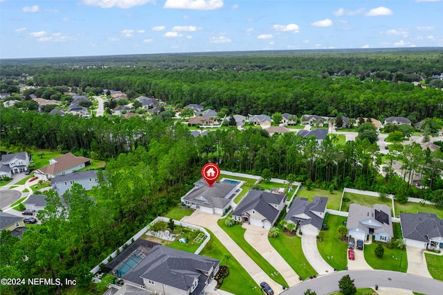 bird's eye view featuring a residential view and a wooded view