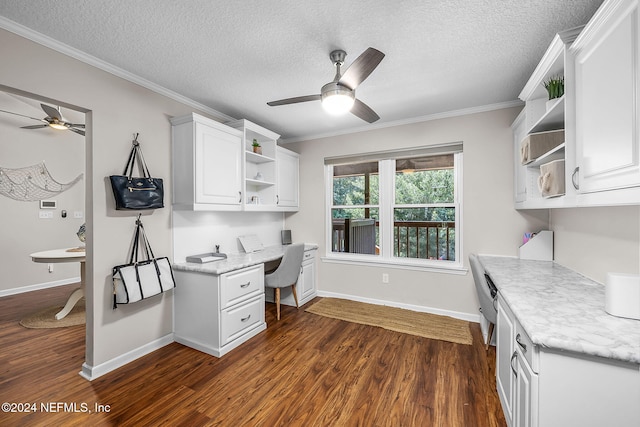 office area with ceiling fan, a textured ceiling, dark wood-type flooring, ornamental molding, and built in study area