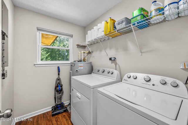 laundry room featuring a textured ceiling, water heater, dark wood-type flooring, and washer and clothes dryer