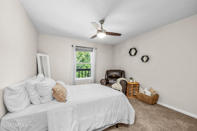 bedroom with a textured ceiling, carpet floors, ceiling fan, and baseboards