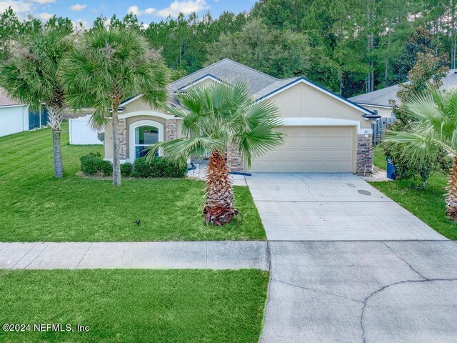 single story home featuring a garage and a front lawn