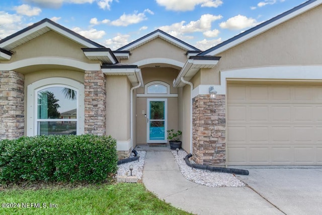 doorway to property with a garage