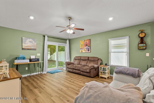 living room featuring ceiling fan and light wood-type flooring