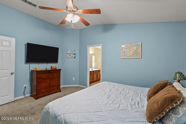 bedroom with ceiling fan, connected bathroom, light colored carpet, and lofted ceiling