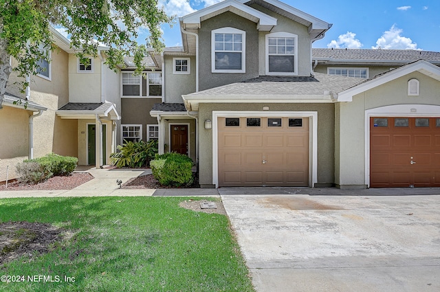 view of front facade featuring a garage and a front lawn