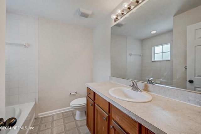 full bathroom with toilet, tiled shower / bath combo, vanity, and tile patterned floors