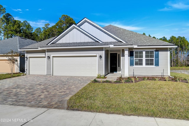 view of front facade with a front yard and a garage