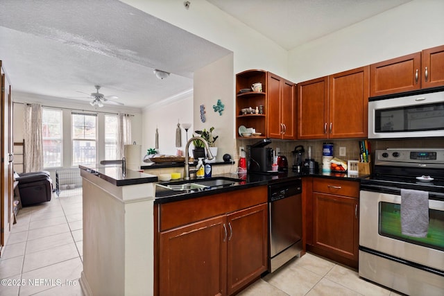 kitchen with stainless steel appliances, sink, light tile patterned floors, and kitchen peninsula