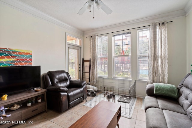 living room with ornamental molding, plenty of natural light, light tile patterned floors, and a textured ceiling