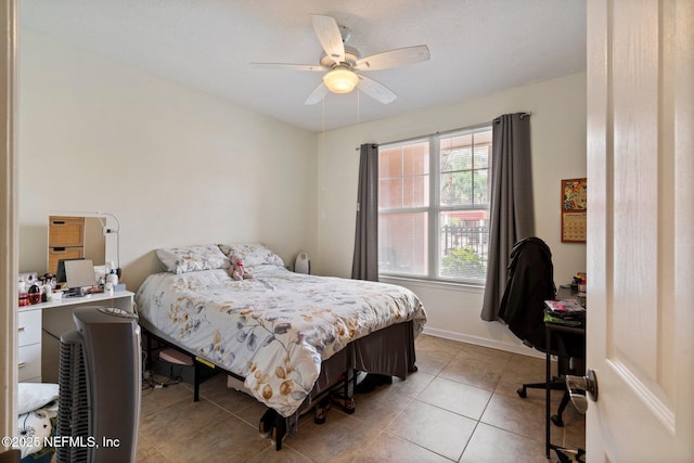 bedroom with ceiling fan and light tile patterned floors