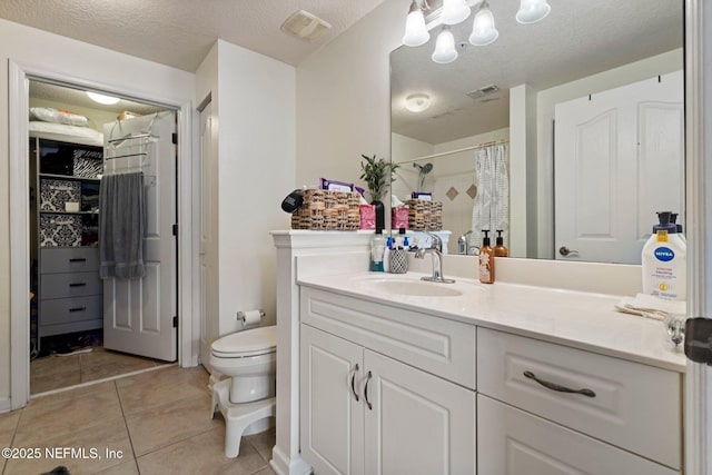 bathroom featuring a shower with curtain, vanity, tile patterned flooring, and a textured ceiling