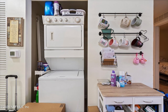 washroom with stacked washer and dryer