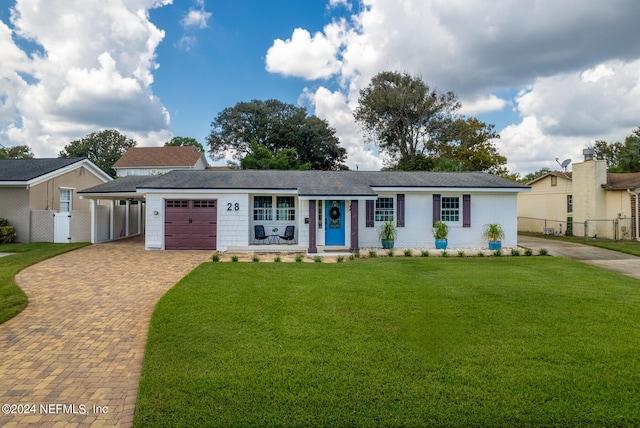 ranch-style house featuring a front lawn and a garage