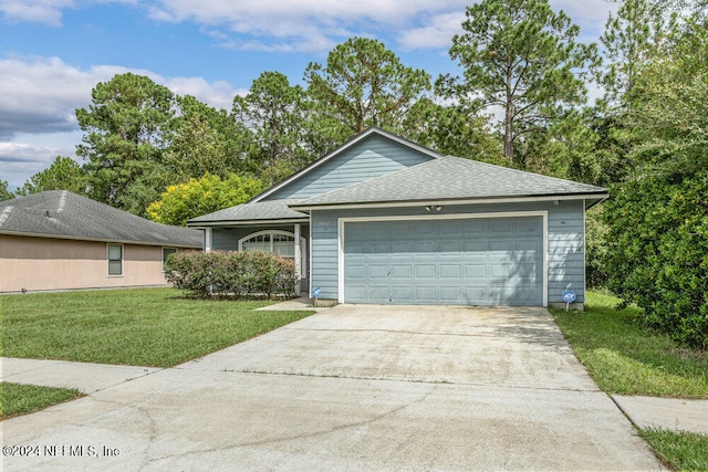 view of front of property featuring a front yard and a garage