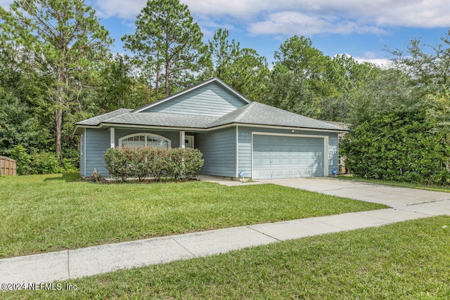 view of front of property featuring a front yard and a garage